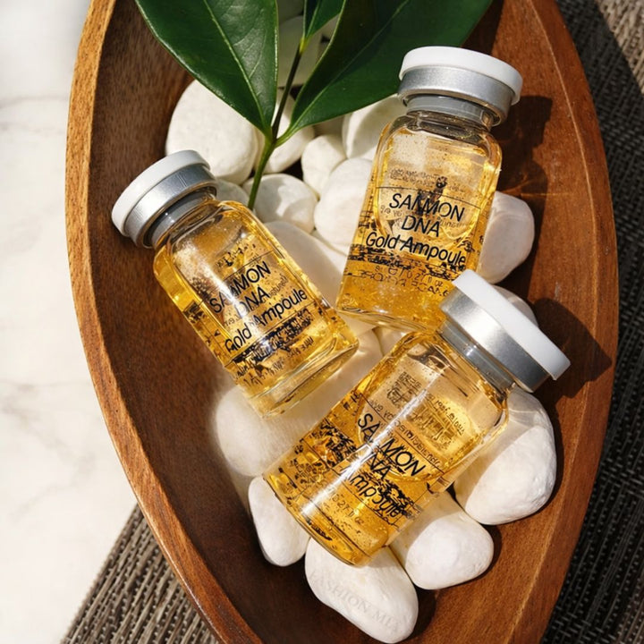 Dermalux Salmon DNA Gold Ampoule Serum Kit by Aarwaan showing three gold-colored ampoule vials and skincare packaging.